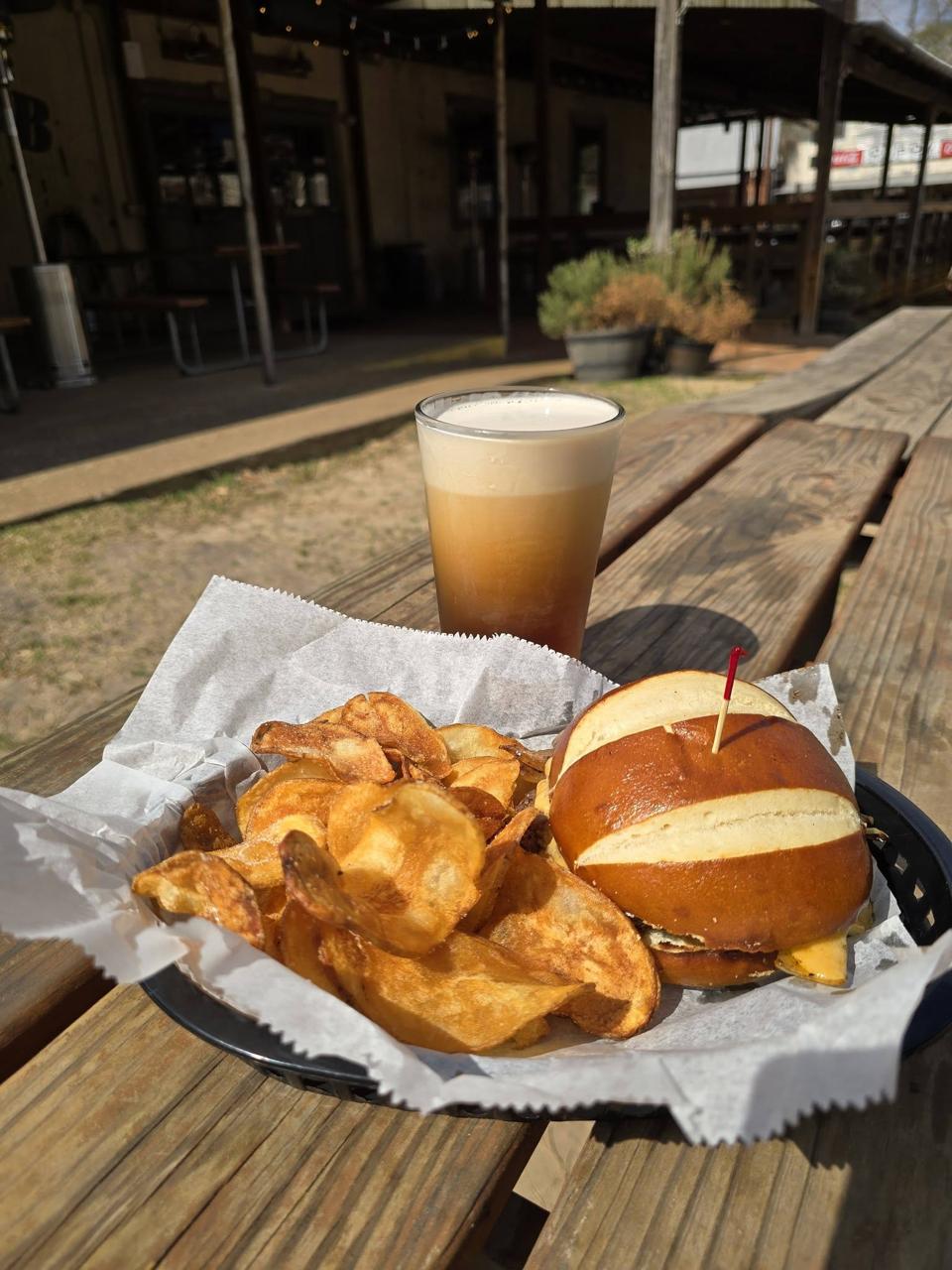 Pretzel sandwich with chips and craft beer